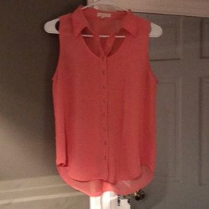 Pretty coral sleeveless blouse.